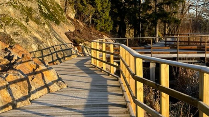 Gångbrygga i trä längs en bergskant