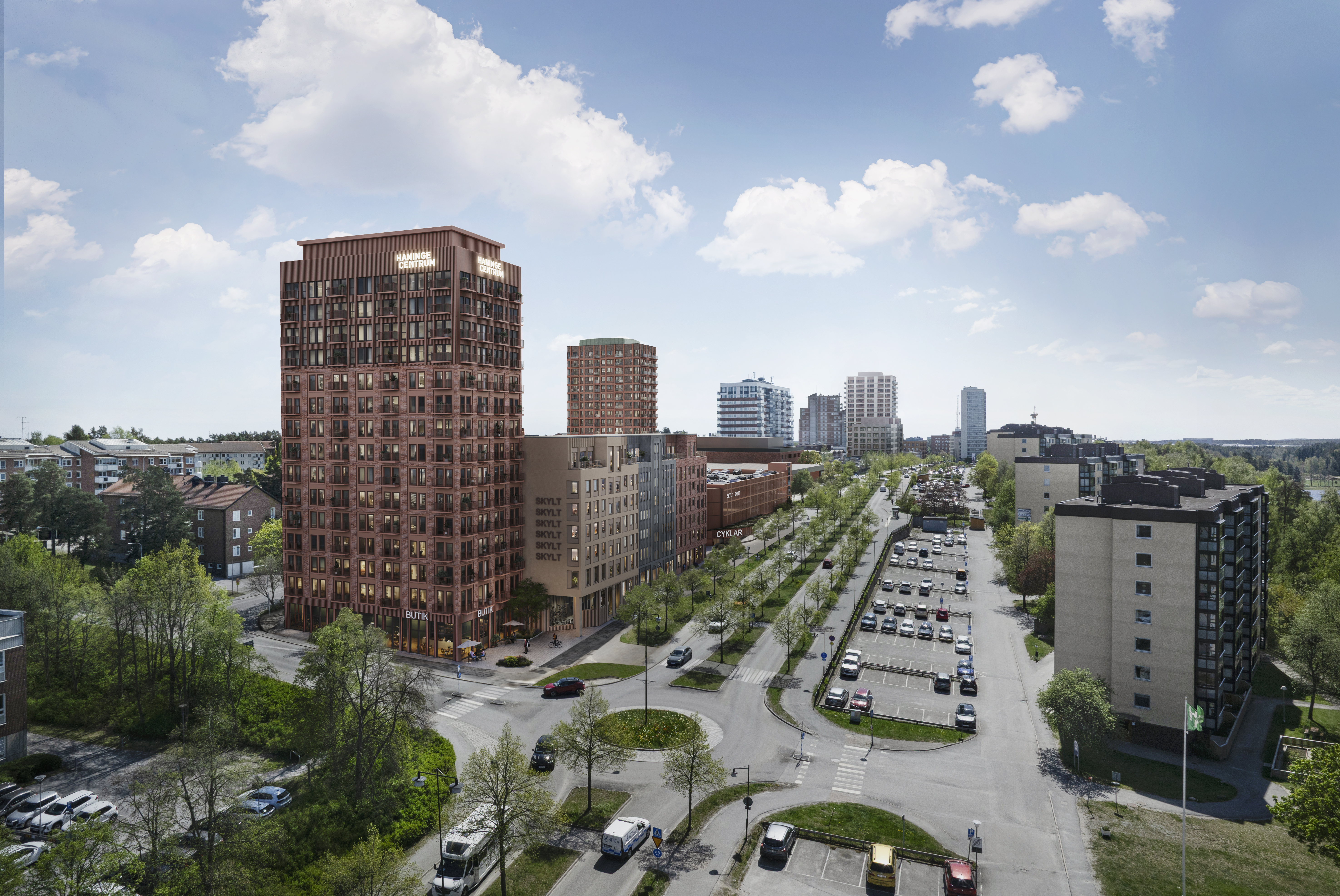 Visionsbild över det nya norra bostadskvarteret. På bilden syns ett högre hus med tegelfasad och ytterligare byggnader nedanför.